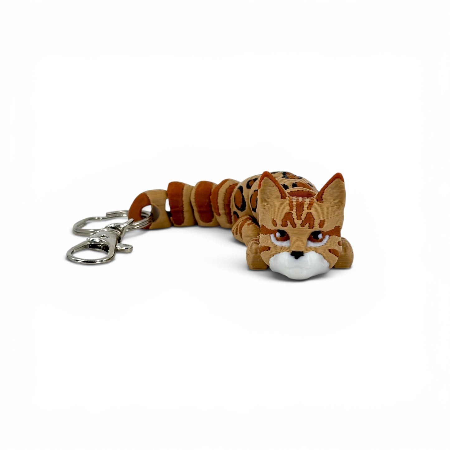 orange and tan cat-shaped keychain on a white background