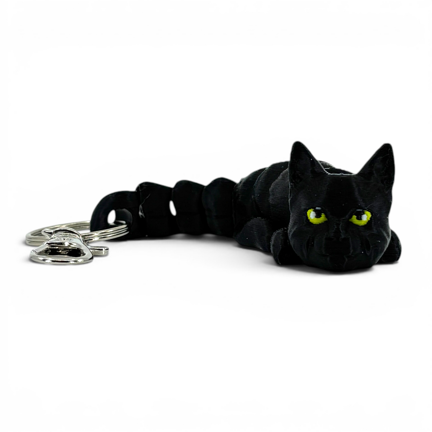 Black cat keychain with yellow eyes on a white background