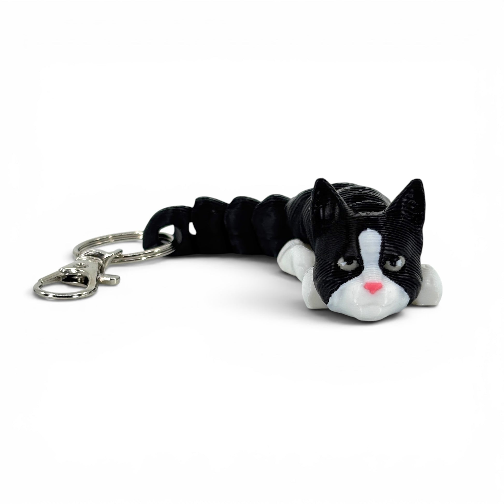 Black and white cat with pink nose keychain on a white background