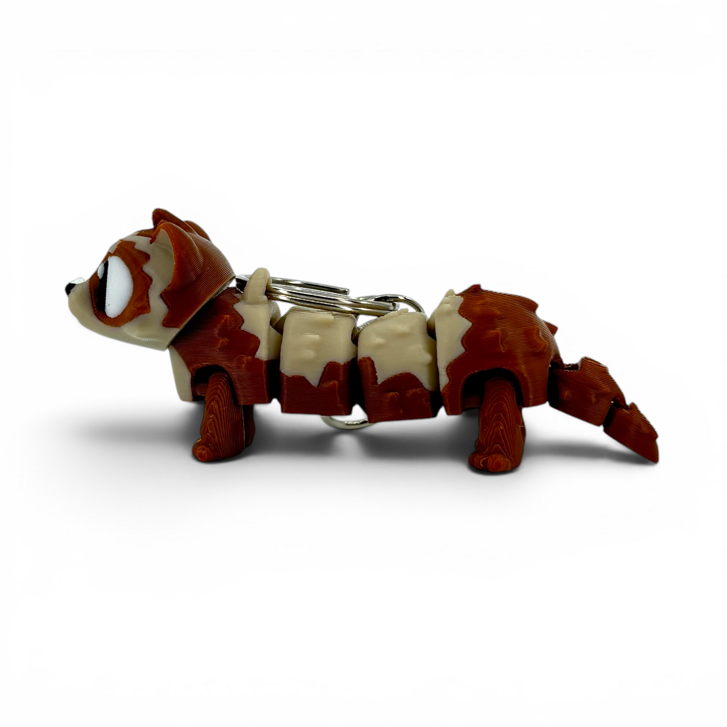 ferret with large eyes keychain on a white background