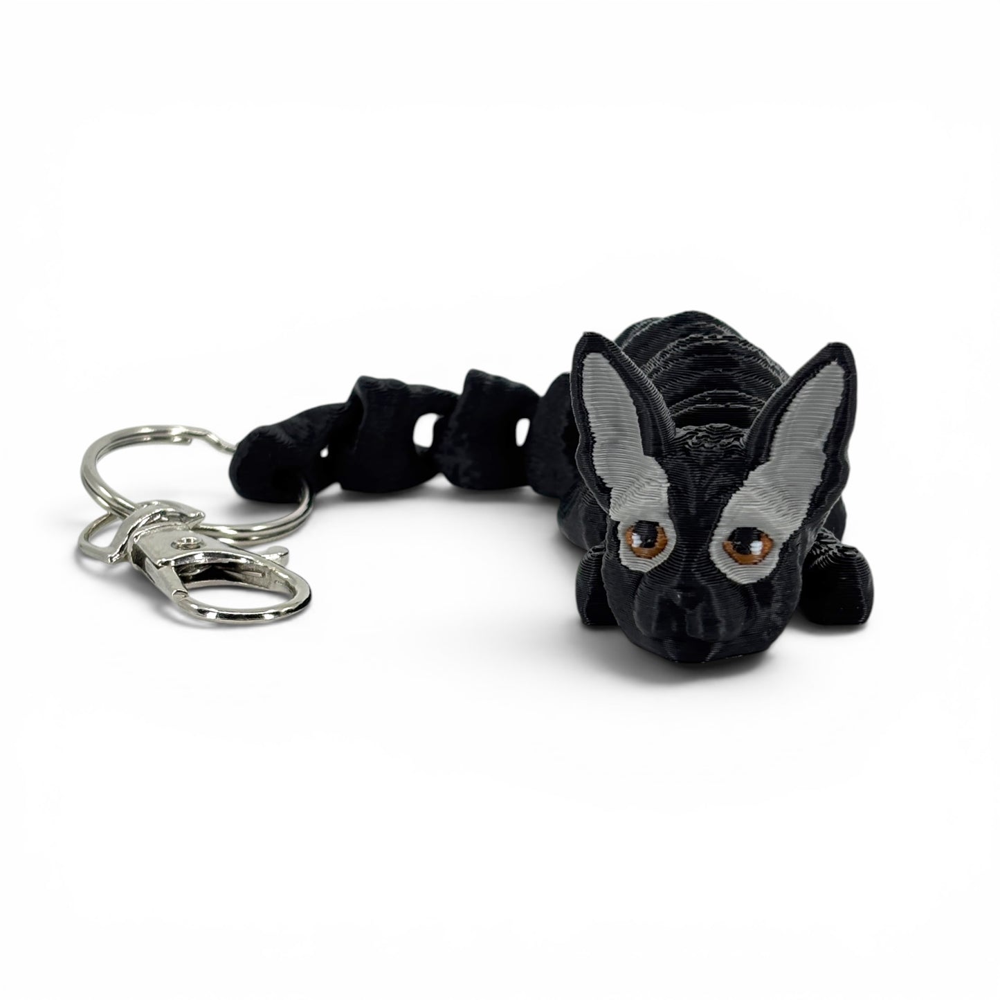 Black and gray cat keychain with a metal clasp on a white background