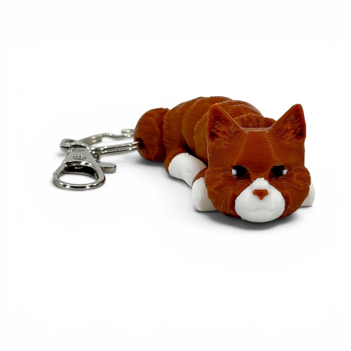 Brown and white cat keychain on a white background