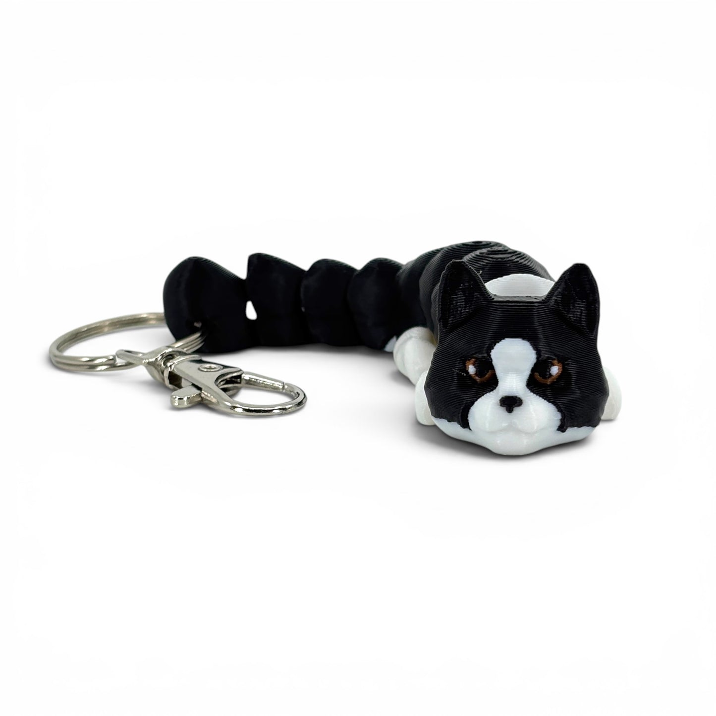 Black and white cat-shaped keychain on a white background