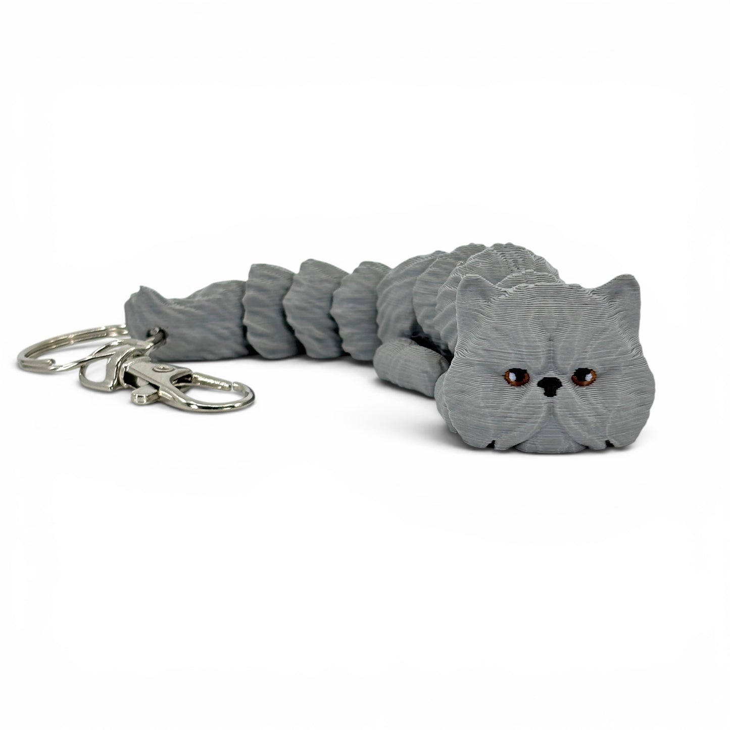 Gray cat-shaped keychain on a white background