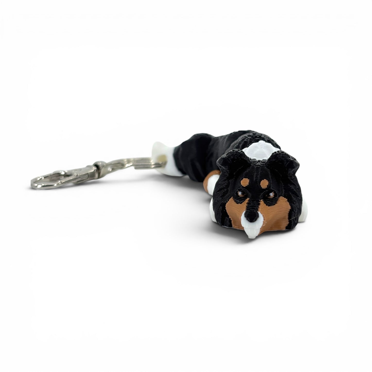 Front view of Rough Collie keychain in a tricolor pattern in tan, black and white.
