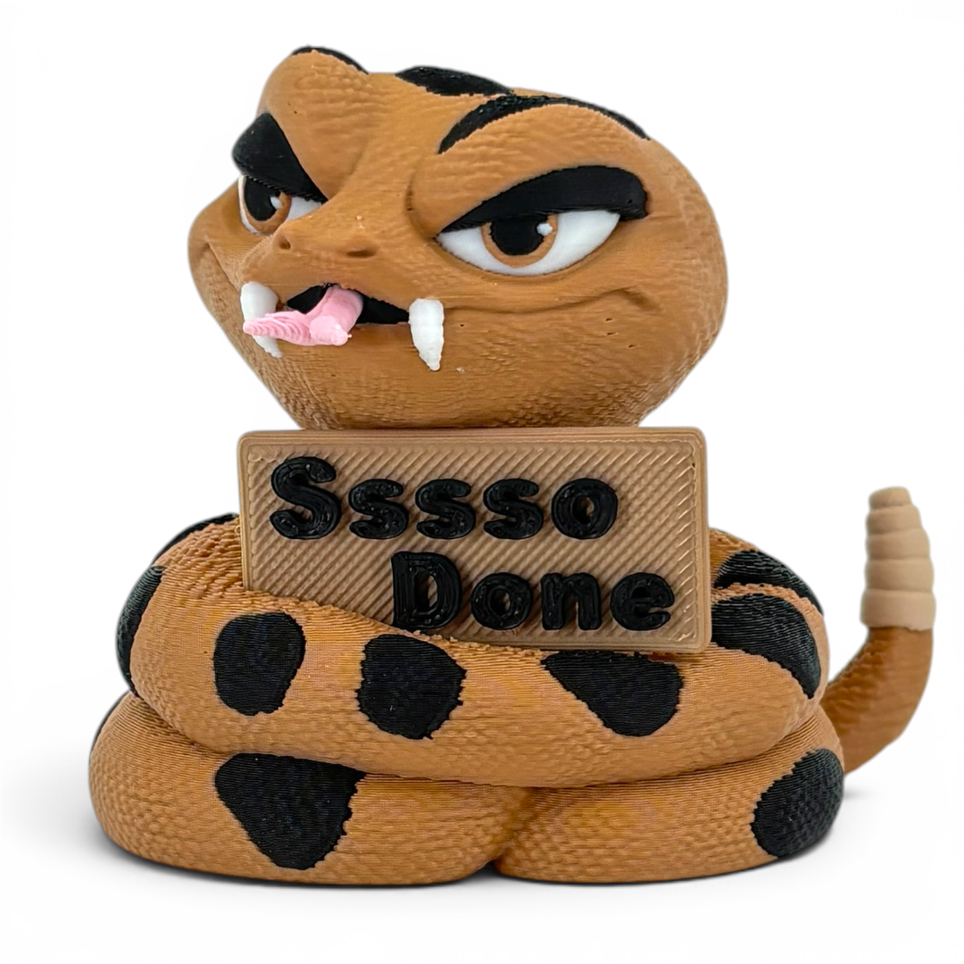 3D printed rattlesnake with a sign saying 'Sssso Done' on a white background