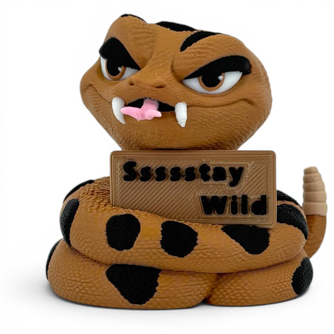 3D printed rattlesnake with a sign saying 'Sssstay Wild' on a white background